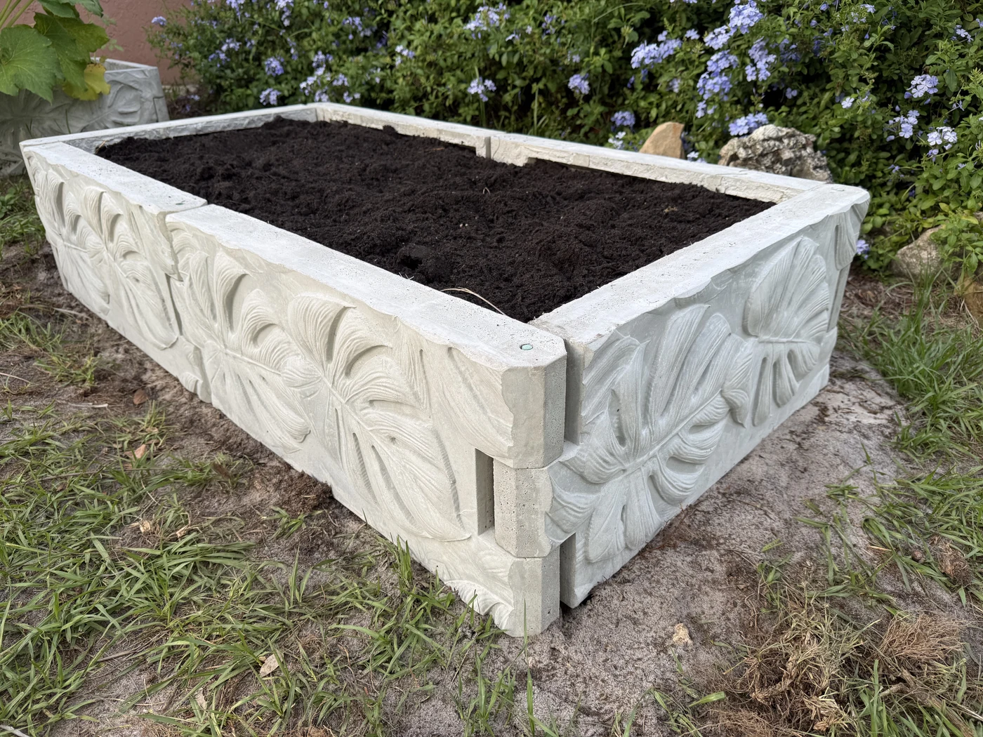 Completed concrete garden bed showing how panels meet at a corner