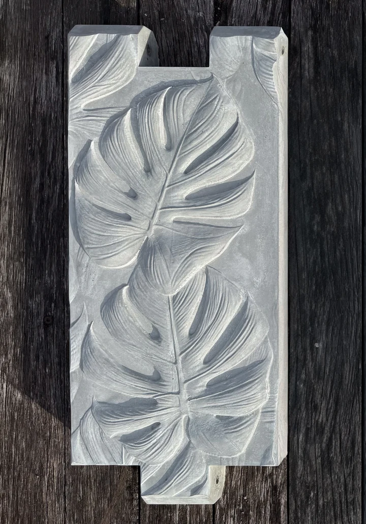 Manatee Grey natural concrete panel with sculpted monstera-leaf relief