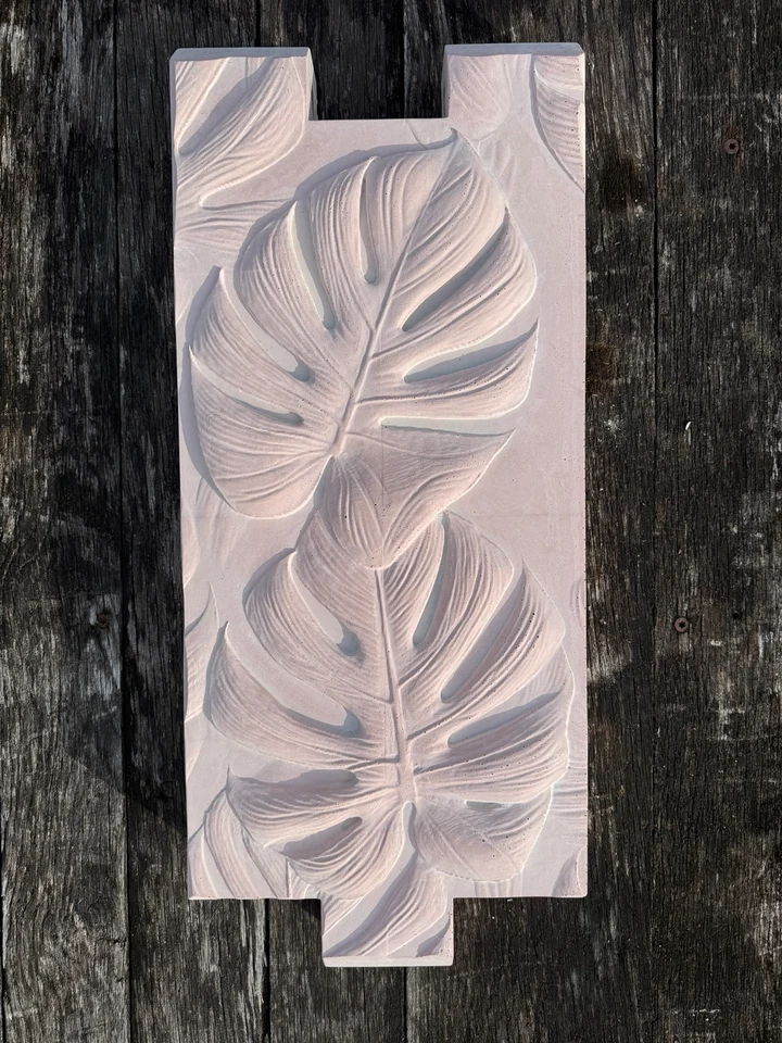 Spoonbill Pink color sample on a sculpted concrete planter panel